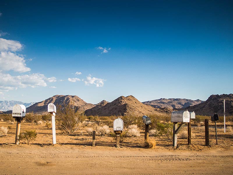 A group of mail boxes in the middle of nowhere.